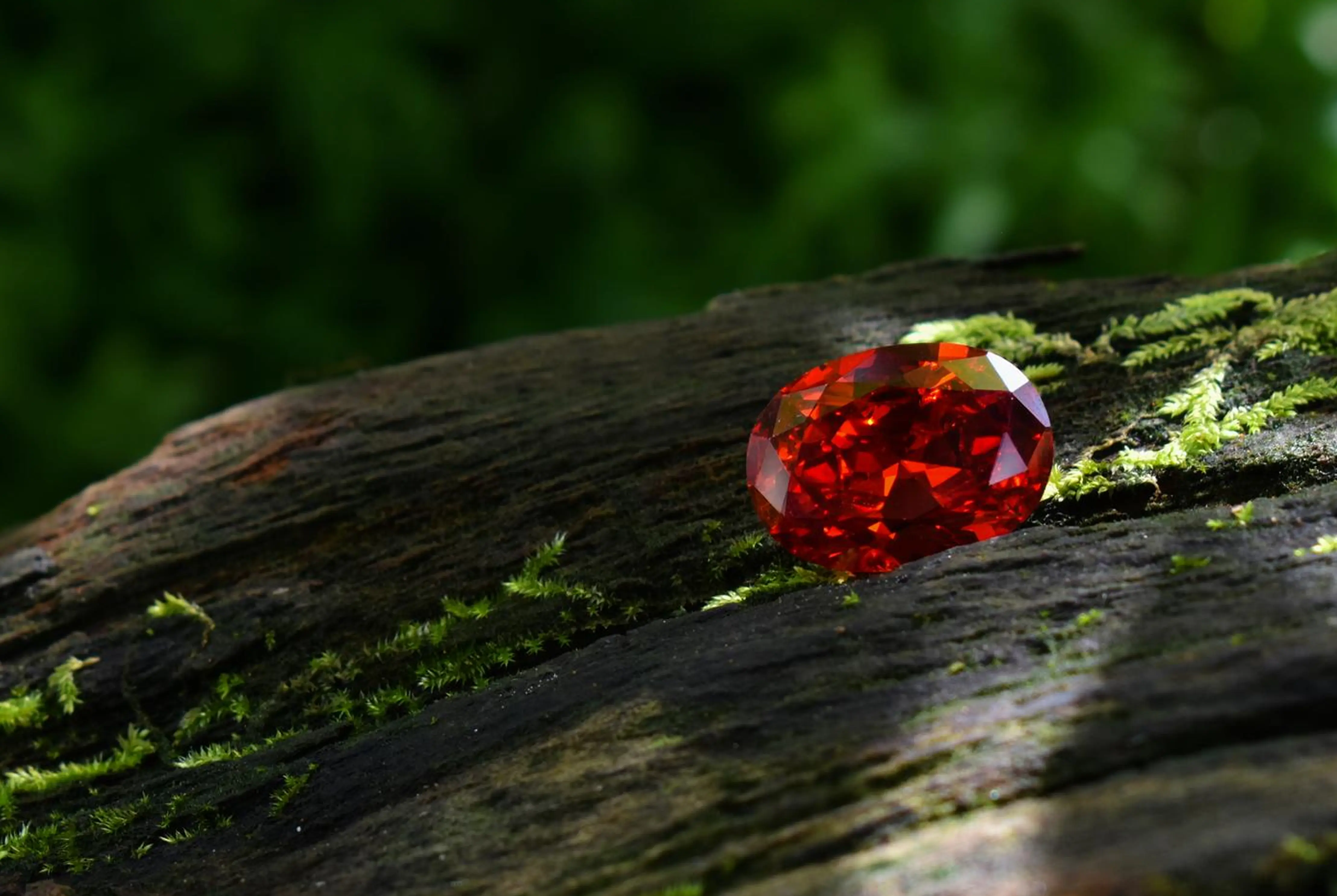 Emerald-cut green gemstone in a rose gold ring